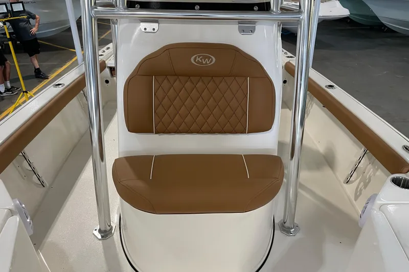 Slide: The Image of 2026 Key West 210 Bay Reef boat interior with brown cushioned seating and stainless steel frame. - 25