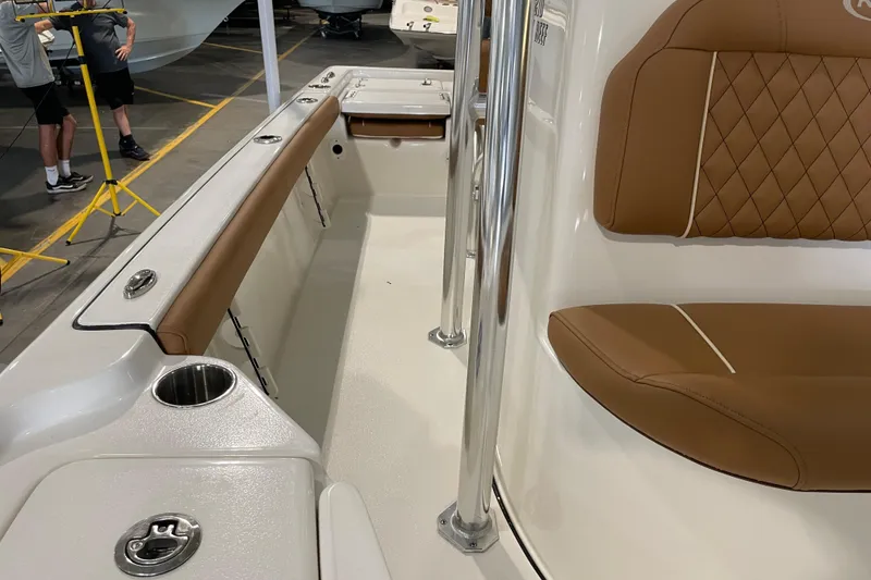 Slide: The Image of 2026 Key West 210 Bay Reef boat interior with tan seating and stainless steel fixtures. - 27