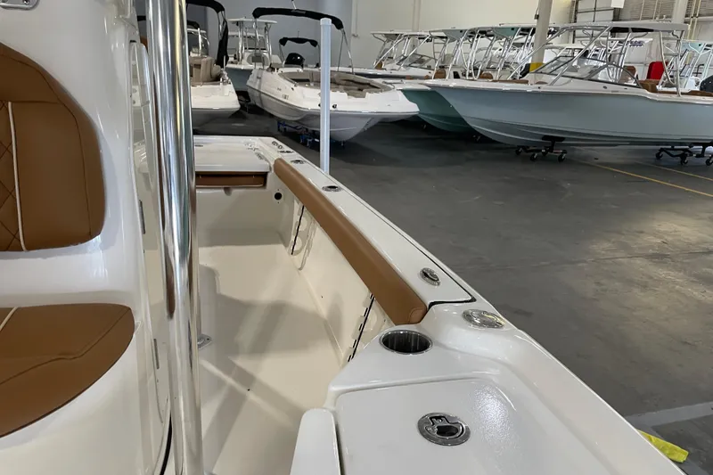 Slide: The Image of 2026 Key West 210 Bay Reef boat interior with tan seating in showroom. - 28