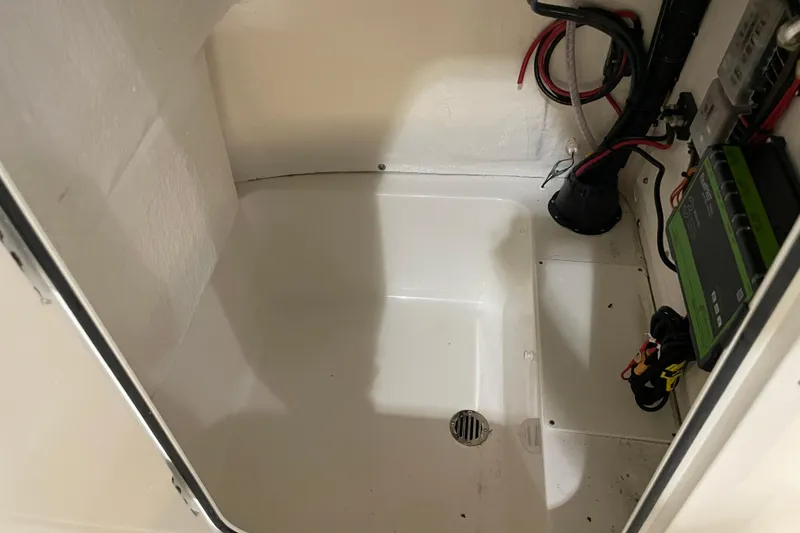 Slide: The Image of 2026 Key West 210 Bay Reef boat compartment with wiring and drainage system. - 30