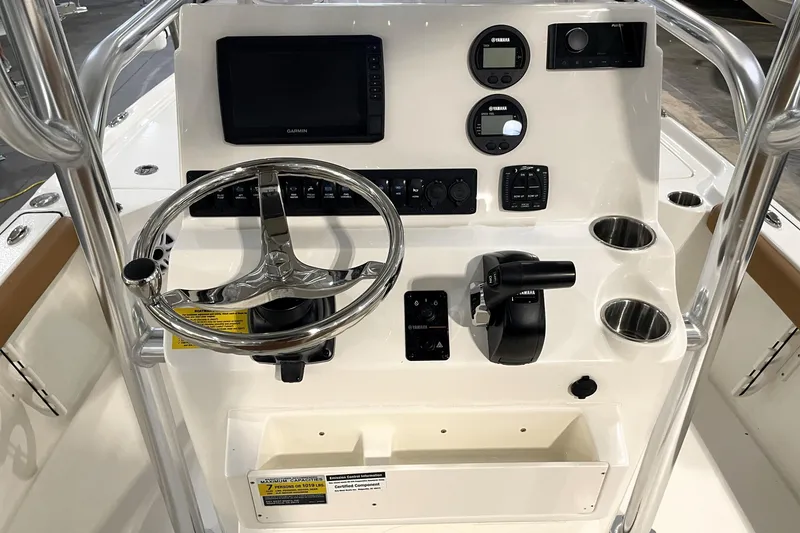 Slide: The Image of 2026 Key West 210 Bay Reef boat console with steering wheel, controls, and cup holders. - 32