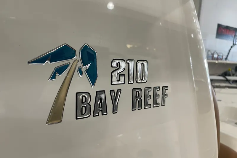 Slide: The Image of 2026 Key West 210 Bay Reef boat logo on white surface. - 44