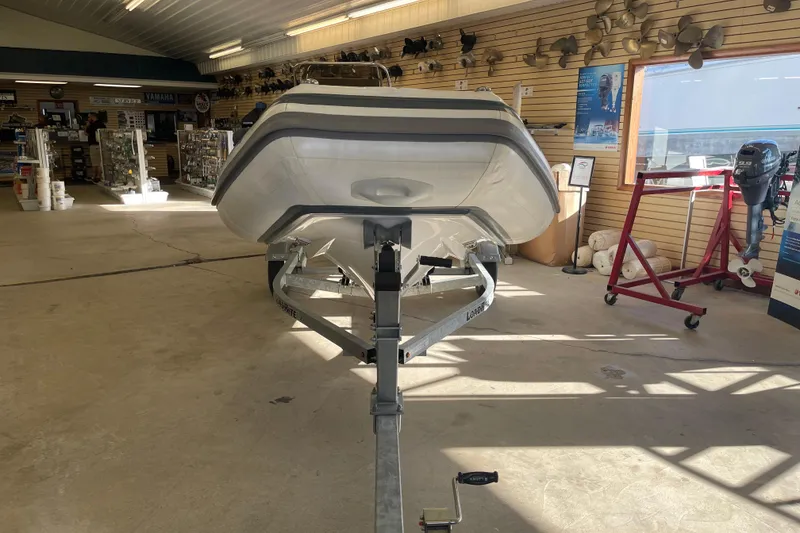Slide: The Image of 2022 Walker Bay Venture 16 boat on trailer in showroom. - 2
