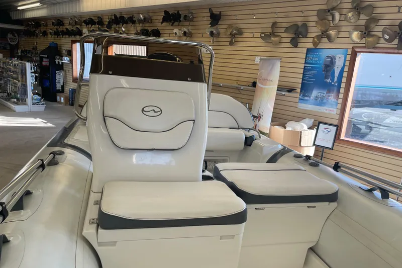 Slide: The Image of 2022 Walker Bay Venture 16 boat interior in showroom with seating and accessories. - 4