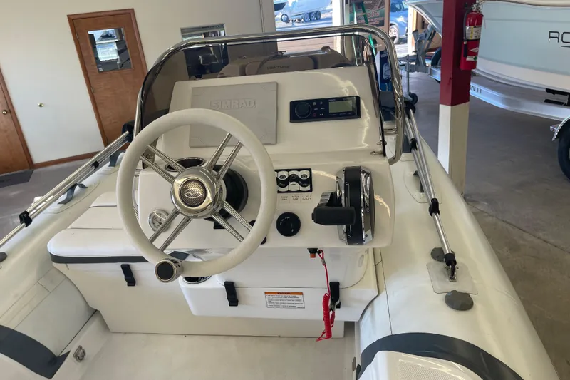 Slide: The Image of 2022 Walker Bay Venture 16 boat interior with steering wheel and control panel. - 5