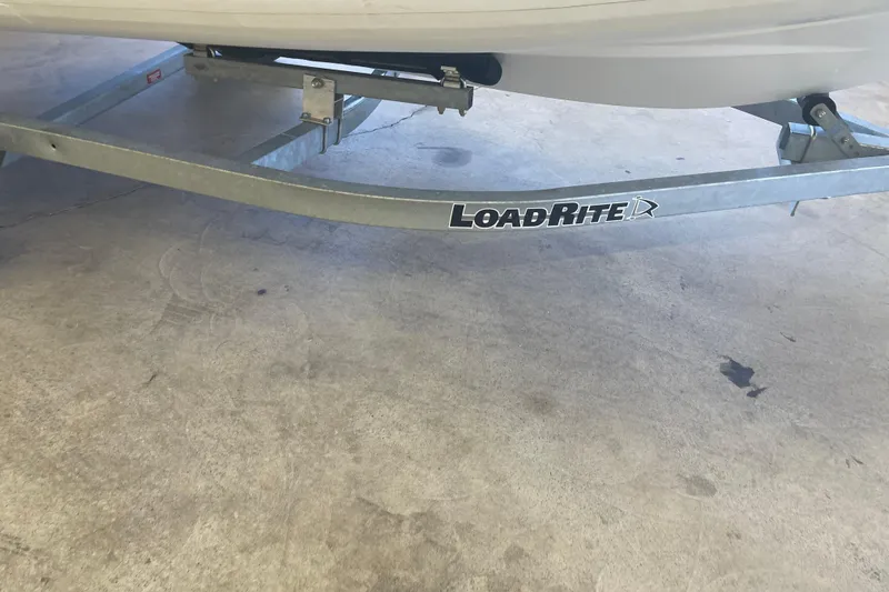 Slide: The Image of Boat trailer with Load Rite branding, supporting a 2022 Walker Bay Venture 16. - 8