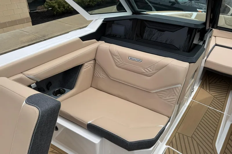 Slide: The Image of 2025 MasterCraft XStar 23 boat interior with beige leather seating and modern design. - 11