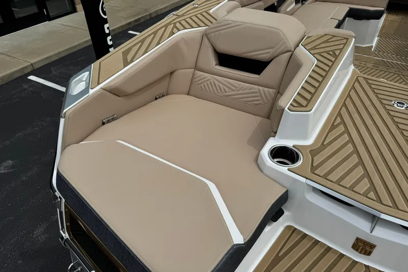 Slide: The Image of 2025 MasterCraft XStar 23 boat interior with tan upholstery and sleek design. - 16