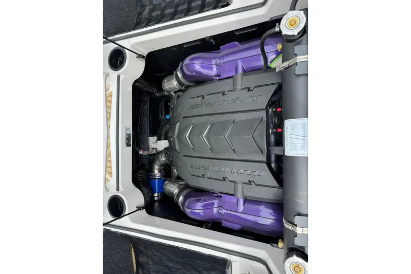 Slide: The Image of Engine compartment of 2025 MasterCraft XStar 23 boat, featuring a supercharged engine. - 18