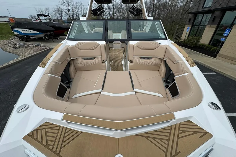 Slide: The Image of 2025 MasterCraft XStar 23 boat with luxurious beige seating and modern design. - 8