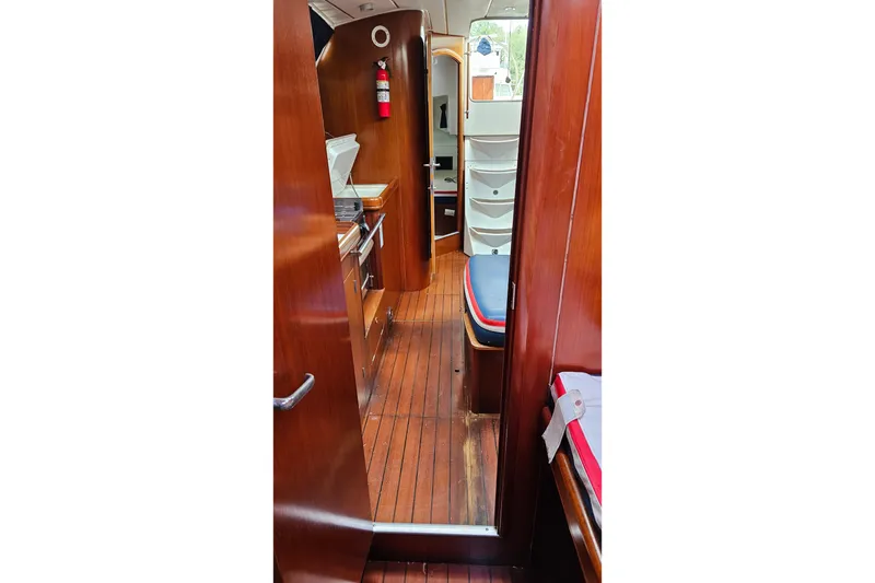 Slide: The Image of Interior of 2003 Beneteau Oceanis Clipper 393 sailboat with wooden flooring and compact kitchen. - 14