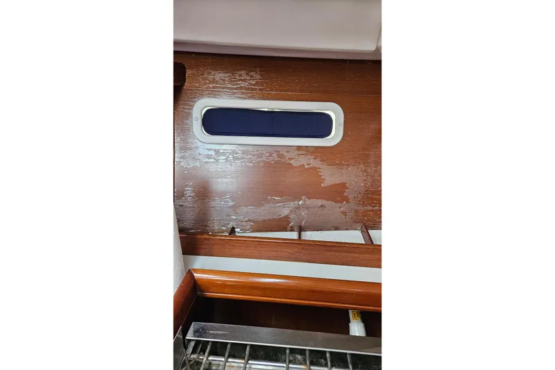 Slide: The Image of Interior of 2003 Beneteau Oceanis Clipper 393 showing wood paneling and window. - 16