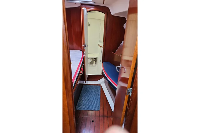 Slide: The Image of Interior of 2003 Beneteau Oceanis Clipper 393 sailboat, featuring wooden finishes and compact design. - 18
