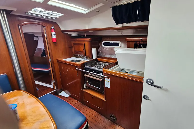 Slide: The Image of Interior of 2003 Beneteau Oceanis Clipper 393 yacht kitchen with wood finish and appliances. - 21