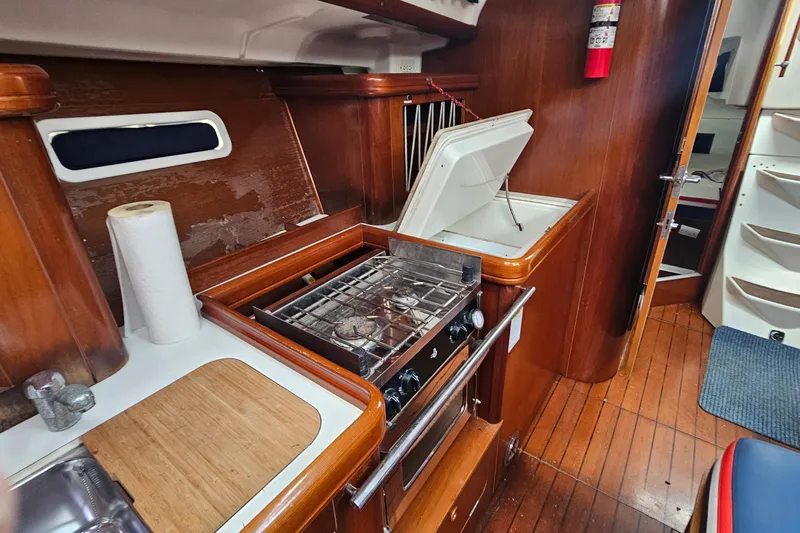 Slide: The Image of Interior of 2003 Beneteau Oceanis Clipper 393 yacht kitchen with stove and wooden cabinetry. - 22