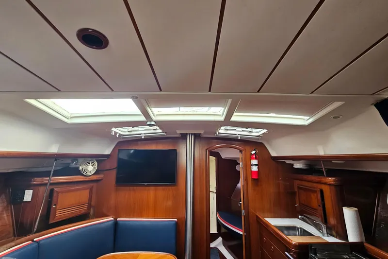 Slide: The Image of Interior of 2003 Beneteau Oceanis Clipper 393 yacht with skylights and wooden finish. - 23