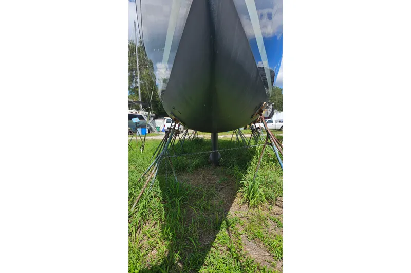 Slide: The Image of 2003 Beneteau Oceanis Clipper 393 sailboat on land, supported by stands. - 28