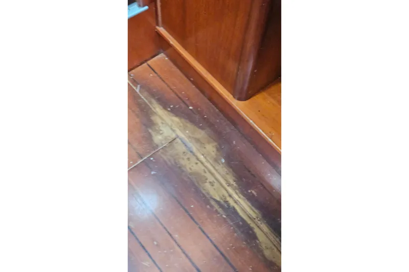 Slide: The Image of Worn wooden floorboards on a 2003 Beneteau Oceanis Clipper 393 yacht interior. - 31