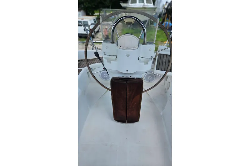 Slide: The Image of Steering wheel of 2003 Beneteau Oceanis Clipper 393 sailboat, featuring a wooden console. - 4