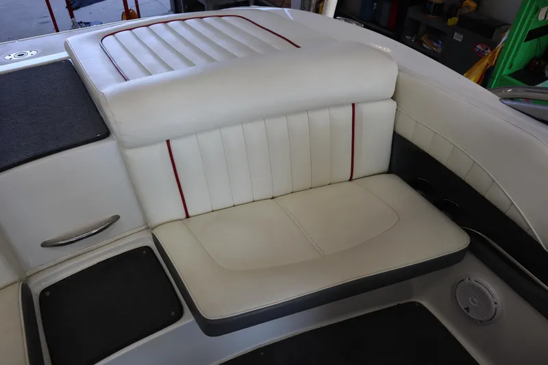 Slide: The Image of 2006 Cobalt 220 boat interior with white leather seating and red accents. - 16
