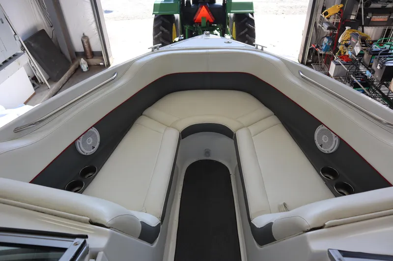 Slide: The Image of Interior of a 2006 Cobalt 220 boat with white seating and cup holders. - 2