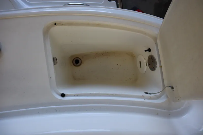 Slide: The Image of Open storage compartment on a 2006 Cobalt 220 boat, showing interior details. - 22