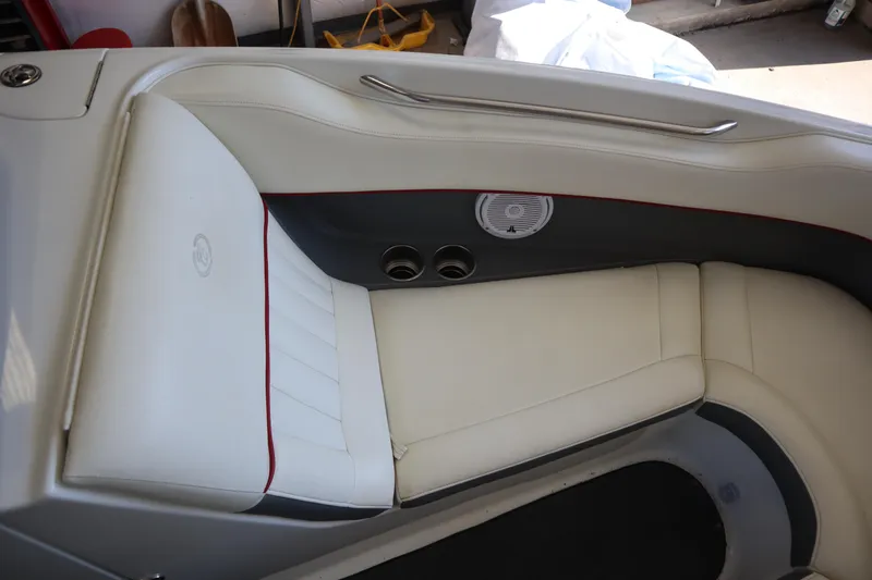 Slide: The Image of 2006 Cobalt 220 boat interior with white leather seating and speaker detail. - 3