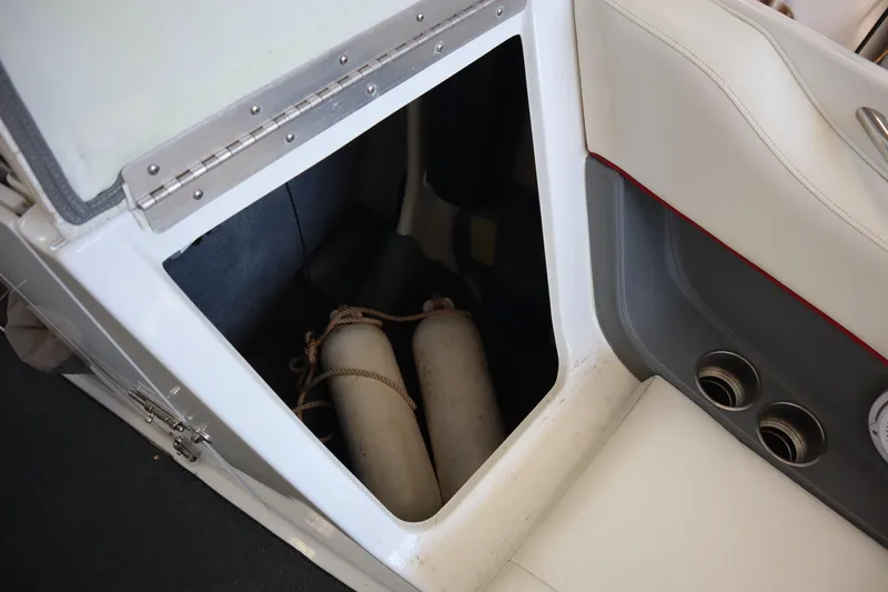 Slide: The Image of Storage compartment in a 2006 Cobalt 220 boat with fenders inside. - 4