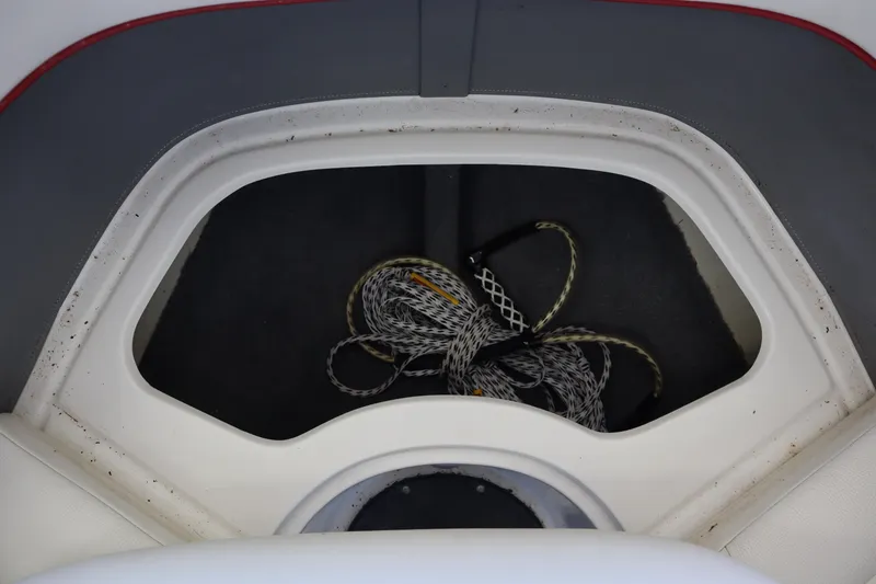 Slide: The Image of Storage compartment with rope in a 2006 Cobalt 220 boat. - 6
