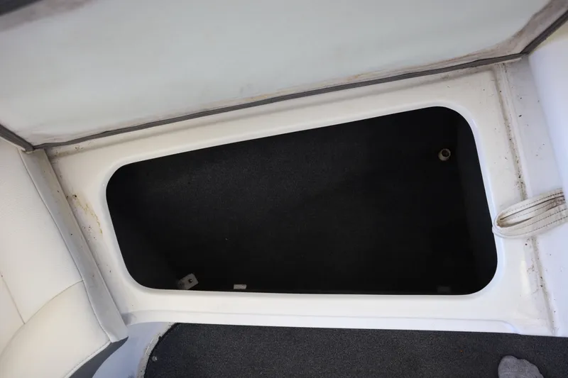 Slide: The Image of Storage compartment in a 2006 Cobalt 220 boat, featuring a clean interior. - 7