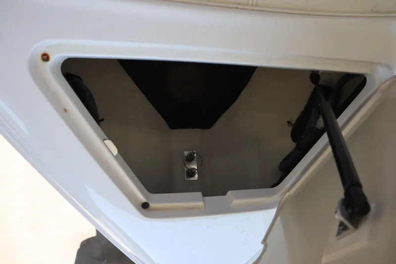 Slide: The Image of Open storage compartment in 2006 Cobalt 220 boat, showing interior details. - 9