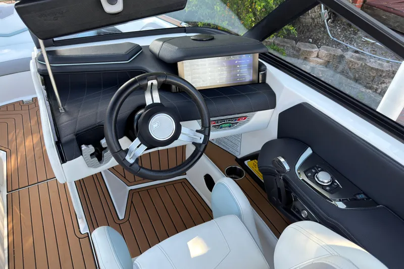 Slide: The Image of 2022 Nautique Super Air Nautique G23 Coastal Edition dashboard with modern steering and controls. - 15