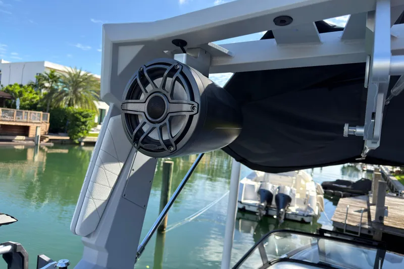 Slide: The Image of 2022 Nautique Super Air Nautique G23 Coastal Edition speaker on a boat, dockside view. - 18