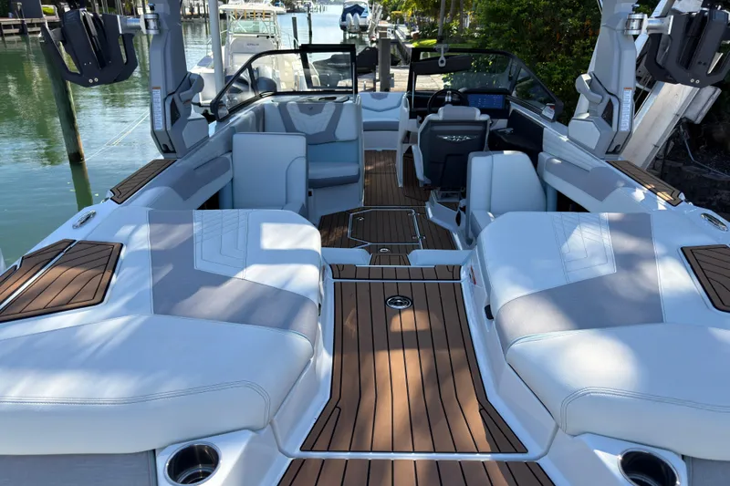 Slide: The Image of 2022 Nautique Super Air Nautique G23 Coastal Edition interior with luxurious seating and teak flooring. - 20