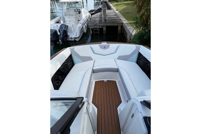 Slide: The Image of 2022 Nautique Super Air Nautique G23 Coastal Edition interior with white seating and wood accents. - 3