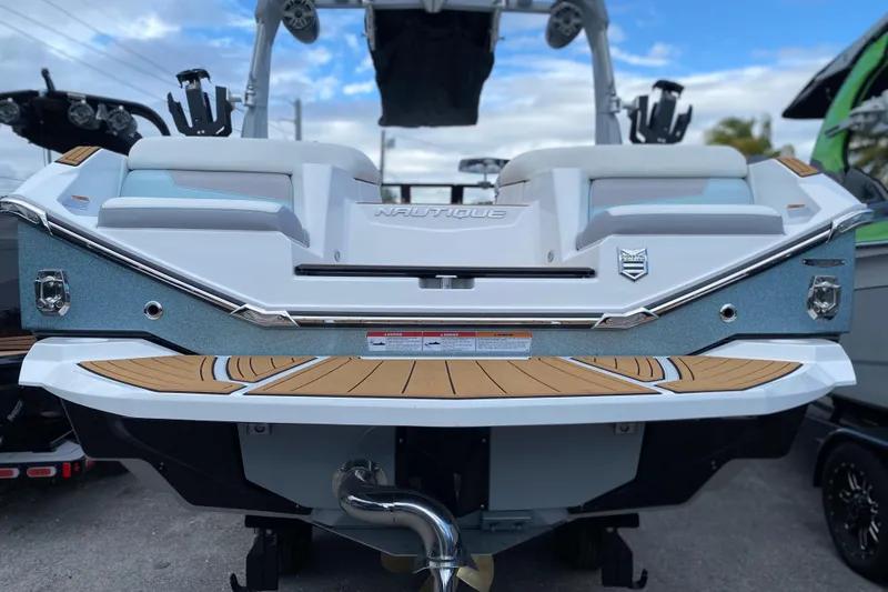 Slide: The Image of 2022 Nautique Super Air Nautique G23 Coastal Edition boat rear view with teak deck. - 4