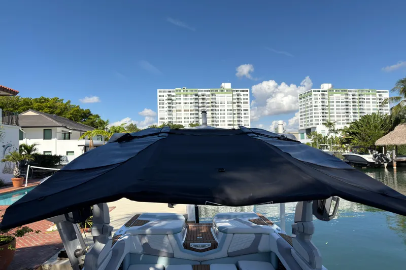 Slide: The Image of 2022 Nautique Super Air Nautique G23 Coastal Edition docked near waterfront buildings. - 9