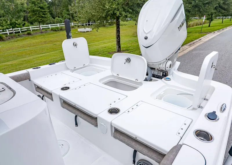 Slide: The Image of 2026 Sea Hunt BX 25 FS boat with open storage compartments and outboard motor. - 10