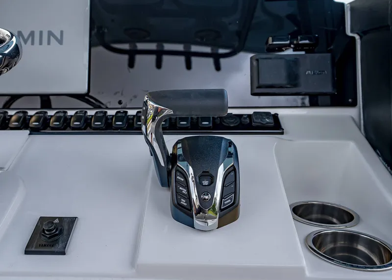 Slide: The Image of Control panel of 2026 Sea Hunt BX 25 FS boat with Yamaha throttle and cup holders. - 15