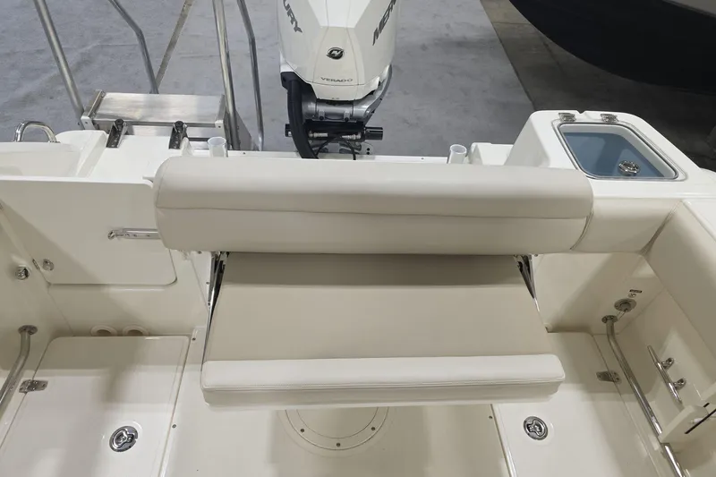 Slide: The Image of 2026 Boston Whaler 230 Outrage boat interior with seating and Mercury engine. - 18