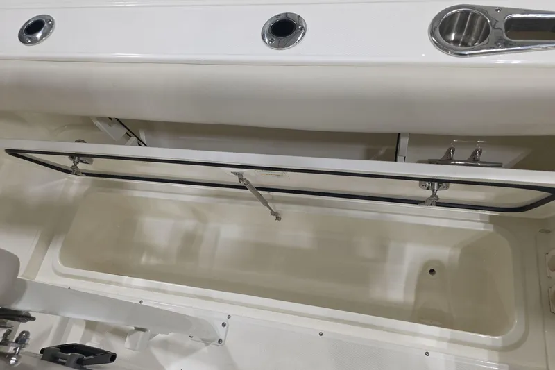 Slide: The Image of Open storage compartment on 2026 Boston Whaler 230 Outrage boat. - 20