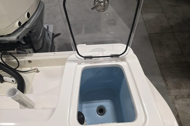 Slide: The Image of Open storage compartment on 2026 Boston Whaler 230 Outrage boat, showcasing interior details. - 22