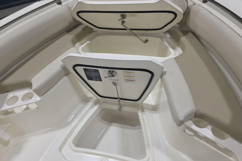 Slide: The Image of 2026 Boston Whaler 230 Outrage boat interior with open storage compartments and seating. - 25