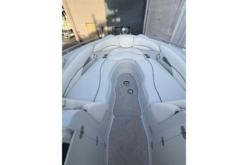 Slide: The Image of 2007 Crownline 320 LS boat interior with white seating and carpeted floor. - 17