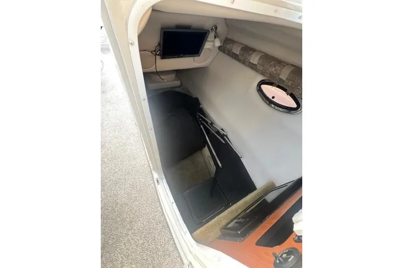 Slide: The Image of 2007 Crownline 320 LS cabin interior with porthole and electronic equipment. - 19