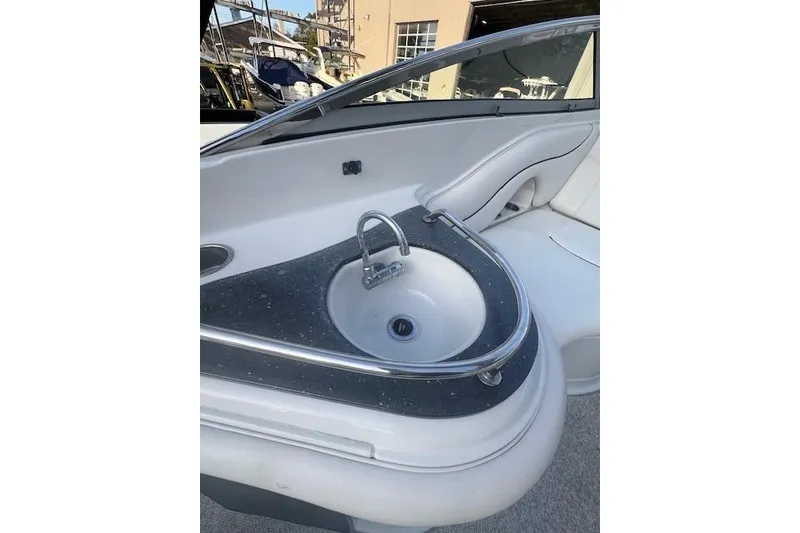 Slide: The Image of 2007 Crownline 320 LS boat interior with sleek sink and seating area. - 25