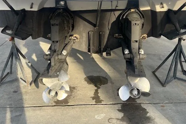 Slide: The Image of 2007 Crownline 320 LS boat propellers on dry dock, showing dual outboard motors. - 28