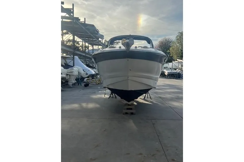 Slide: The Image of 2007 Crownline 320 LS boat on dry dock, front view, with a rainbow in the sky. - 4