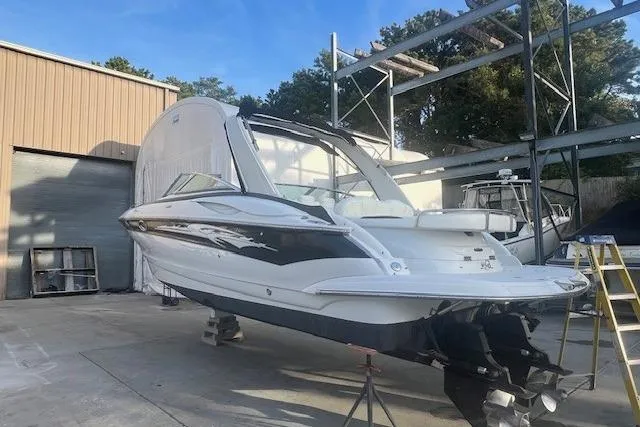 Slide: The Image of 2007 Crownline 320 LS boat on dry dock, outdoor storage area, clear sky. - 6
