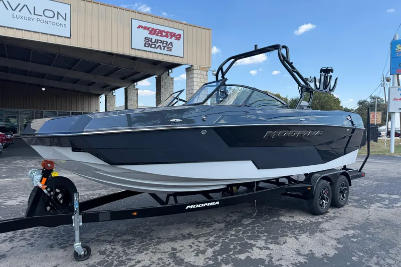 The Image of 2026 Moomba Tykon boat on trailer at dealership, showcasing sleek design and modern features. - 1